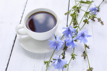 Obraz na płótnie Canvas Cup of coffee tea chicory drink with chicory flower on a white table