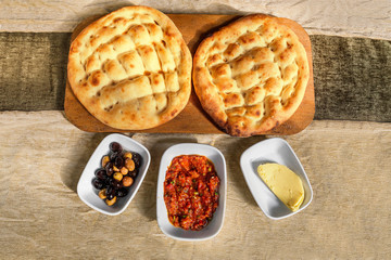 Olives, sauce and homemade pita bread served as traditional turkish breakfast, flat top view