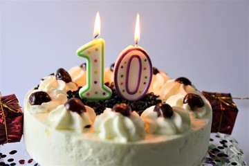 An image of a birthday cake with candles - 10 
