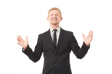 Portrait of ecstatic young businessman in black suit on white background