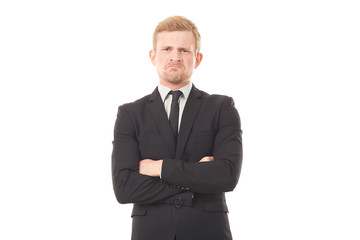 Portrait of displeased businessman in black suit on white background