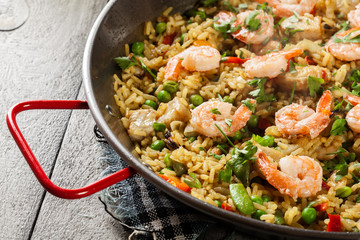 Traditional seafood paella with shrimp, fish and chicken seved i