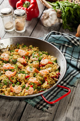 Traditional seafood paella with shrimp, fish and chicken seved i