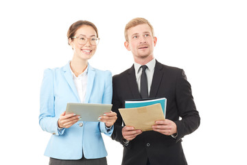 Portrait of Asian businesswoman and Caucasian businessman holding tablet computer and documents
