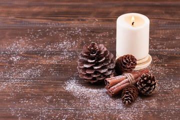 Fototapeta na wymiar Christmas decoration. Pine and fir cones with cinnamon sticks on wood table