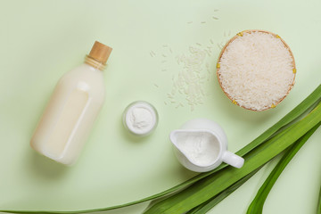 Milk and rice in bowl on light background.
