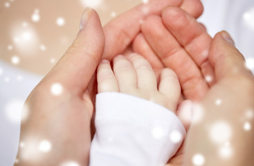 close up of mother and newborn baby hands