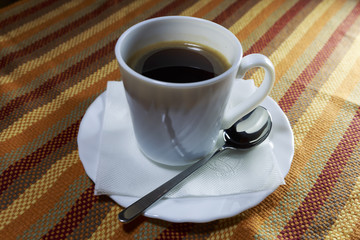Black Coffee in White Cup on Colorful Napkin