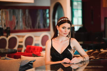 Portrait of beautiful woman holding glass of martini