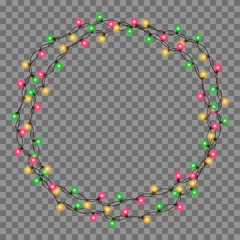 Christmas tree string garland in circle shape and text space isolated on dark background. Realistic Christmas, New Year party decorations with transparency. Light bulb decor. Lights border