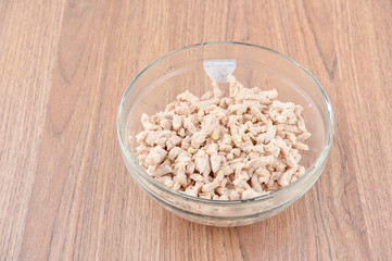 chicken breast meat strips in glass bowl