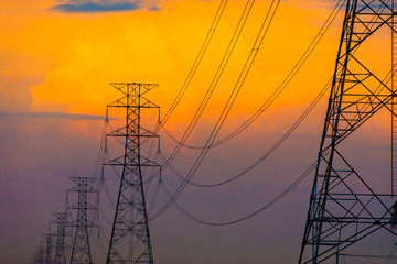 Electricity station. Close up high voltage power lines at sunset.