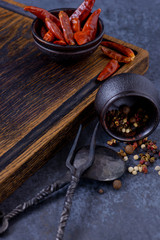 Empty wooden board for meat and red pepper