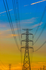 Electricity station. Close up high voltage power lines at sunset.
