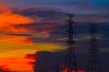 Naklejka premium Electricity station. Close up high voltage power lines at sunset.