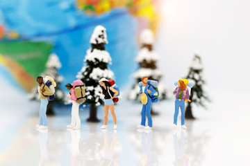 Miniature people, backpackers with globe walking to destination. Concept of Travel around the world and the adventure.