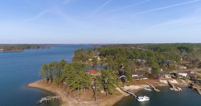 Aerial drone footage over a lake neighborhood in the forest