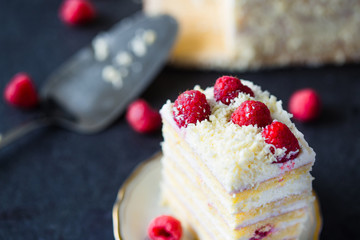 Piece of Raspberry Cheesecake with White Chocolate and Raspberry Jam on Plate on Dark Background, Close Up View