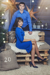 Obraz premium Beautiful young couple man and woman together in the happy Christmas