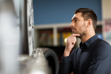 male customer choosing wheel rims at car service
