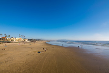 Fototapeta na wymiar Waiting for the Sun to set at Pismo Beach, Oceano Dunes Natural Preserve, California, USA