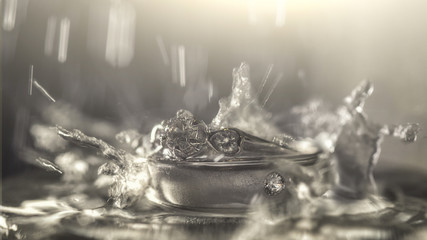 Wedding ring in the water with water drop