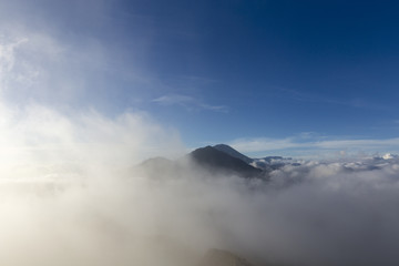 Fototapeta na wymiar Mount Kintamani and Mount Agung shrouded in Mist from the Summit of Mount Batur in Bali, Indonesia.
