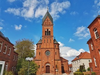 Fototapeta na wymiar Facade of the Catholic Church against the blue sky, the city of Bremen