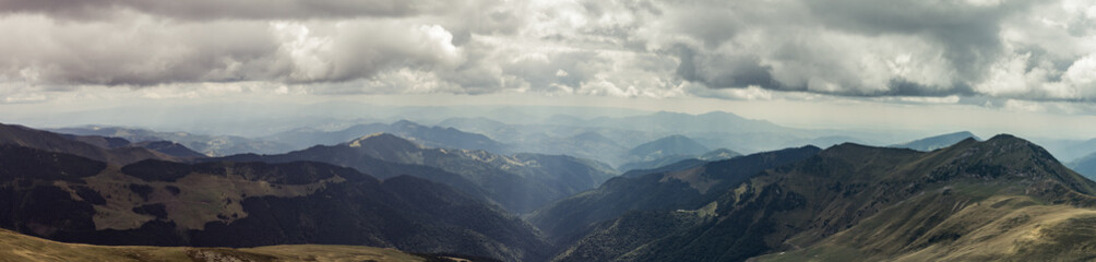 Beautiful view on Rodna mountains with dramatic sunshine through clouds at Romania country