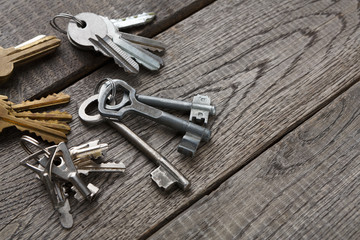 Set of new metal keys on aged wood