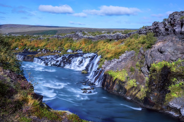 Many waterfalls, a beautiful fast river. sunlight beautiful day. Iceland. Cascade of waterfalls in the gorge.
