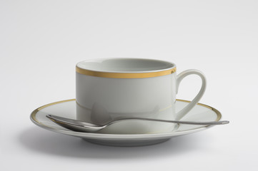 Cup and saucer for tea decorated with gold thread and spoon