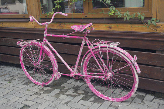 Pink vintage bicycle as a cafe decoration. Urban
