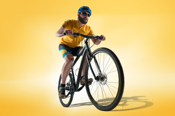 Fototapeta na wymiar The bicyclist on gray, studio shot.
