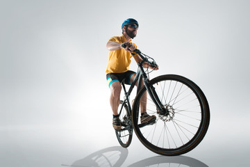 The bicyclist on gray, studio shot.