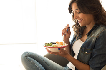 Woman eating a vegan bowl