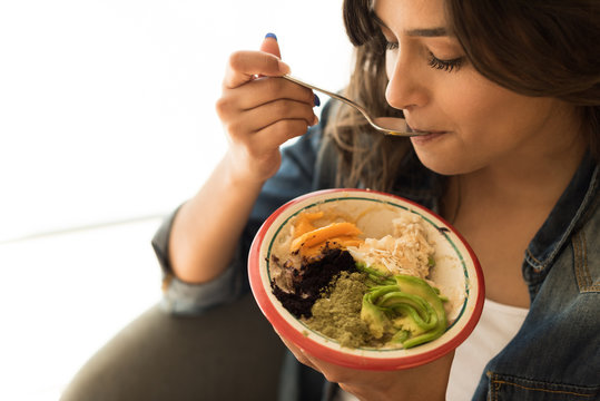 Woman eating a vegan bowl