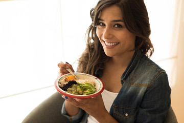 Woman eating a vegan bowl