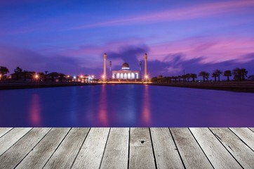 wooden terrace or desk with copy space for display of product or object presentation with colorful sunset at beautiful mosque background