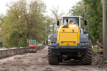 wheel loader clears the road during construction work
