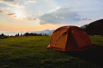 tent in the sunset overlooking mountains and a valley