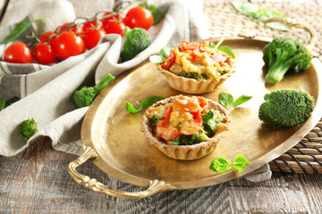 Delicious crispy tarts with broccoli on metal tray