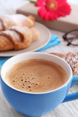 Cup of aromatic morning coffee on wooden table