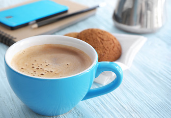 Cup of aromatic morning coffee on wooden table