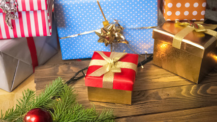 Colorful Christmas gifts and present on wooden background. Perfect image for holidays and winter celebrations