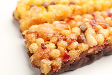 Yummy cereal bars on white background, closeup