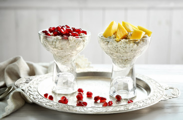 Glass dessert bowls with delicious chia seed pudding on table
