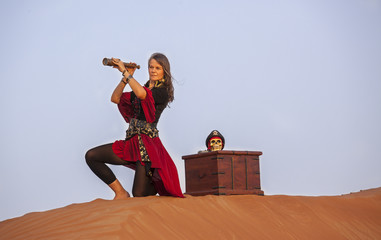 lady pirate in a desert with a wooden treasure trunk