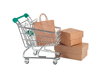 A paper bag, a cardboard box and a supermarket trolley on a white background