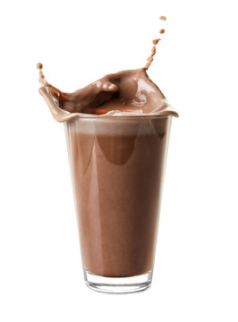 Glass with splashed cocoa on white background